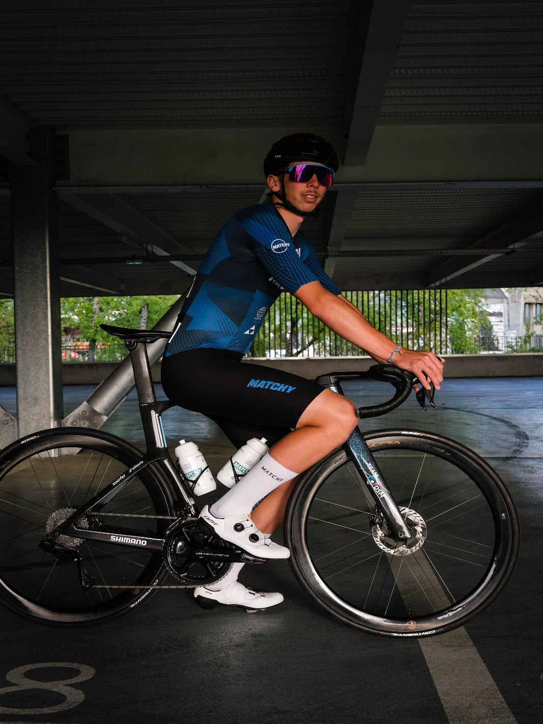 Skinsuit vélo une pièce MATCHY High Performance System, coloris bleu roi et marine, zip intégral, cuissard rembourré, manches courtes.
